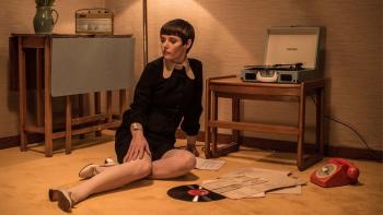 Quant: Woman sitting on floor in front of record player