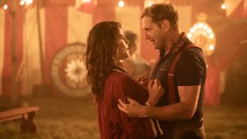 Queen of the Ring movie: Josh Lucas looks meaningfully at Emily Bett Rickards while holding her in an embrace