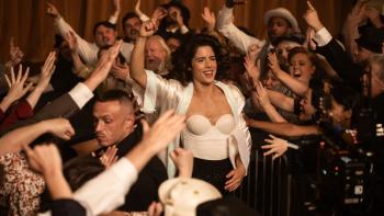 Queen of the Ring movie: Emily Bett Rickards pumps her fist as she walks through a cheering crowd in the 1940s