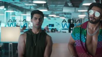 Rocky Aur Rani Kii Prem Kahaani: Two Indian men, one wearing big sunglasses, sit in someone's office.