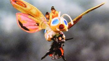 Rebirth of Mothra Movie: Colorful moth-like creature flying through a cloudy sky.