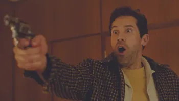Reckless: Man with surprised expression holding a revolver indoors