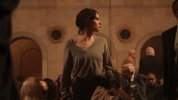 Relay movie: Lily James looks to the right in a crowded building