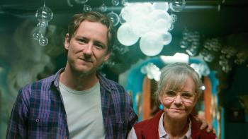 Remarkably Bright Creatures: Lewis Pullman and Sally Field look into a tank.