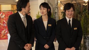 Rental Family movie: Dressed in matching black suits, a Japanese boss speaks to his female assistant, while a younger male colleague smirks