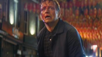 Vengeance -- Rise of the Footsoldier: A White man with bloody injuries on his face stands in a London street at night.