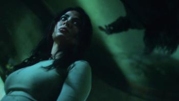 Rosario movie: Rosario is in a state of fear, appearing against a dark background bathed in an eerie green light
