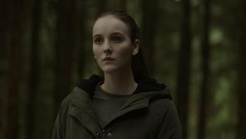 Rose Plays Julie: Woman stands with the woods behind her.