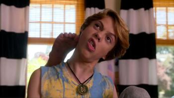 Rufus: A young White boy pulls a face as his foot appears behind his head to scratch his ear