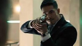 Safe House Movie: Man in suit aims gun