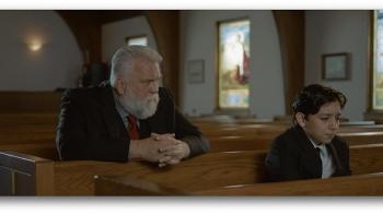 Saint Nick of Bethlehem movie: Daniel Roebuck comforts Elias Kemuel in a church