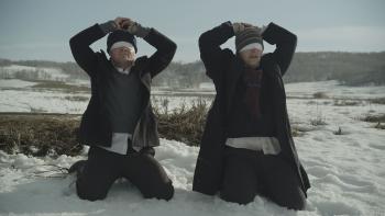 The Saratov Approach Movie: Blindfolded, in coats and hats, the missionaries kneel in the snow, their hands on their heads