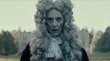 Savage House: Richard E. Grant wears a large, Elizabethan-era wig and a ghostly expression on his face