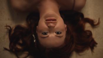 Scrambled Movie: Leah McKendrick lies upside down, looking uncertain
