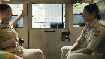 Santosh: Two Indian female police officers talk in the back of a van