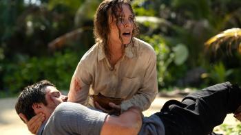 Send Help Movie: An alarmed-looking Linda cradles the injured Bradley and tries to give him water from a coconut shell