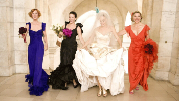 Sex and the City: The Movie: Miranda, Charlotte, Carrie, and Samantha strut down a classic arched hallway in bridalwear