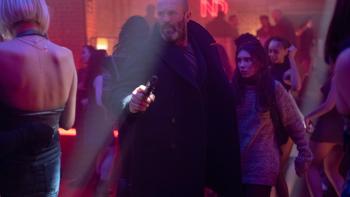 Shelter movie: Jason Statham walks through a nightclub, protecting a tween girl and holding a gun