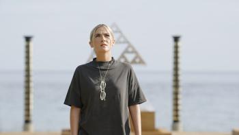 Signal One movie: Isabelle Fuhrman looks up at a building on an island