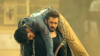 Sikandar: An unconscious man in chains is carried over another man's shoulders