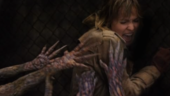 Silent Hill movie: A blonde woman screams in the dark as rotted hands clutch at her back