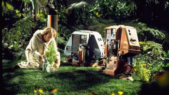 Silent Running: Bruce Dern crouches down to show two robot drones how to plant a tree