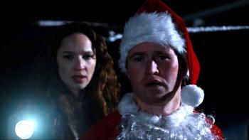 Silent Night, Deadly Night Movie: Pam (Ruby Modine) holds a flashlight as Billy (Rohan Campbell) regards the situation