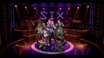 Six the Musical Live! movie: The six wives of Henry VIII pose in a circle on stage