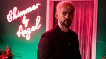 Skincare movie: Luis Gerardo Méndez in a pink and green room with a pink neon sign reading Shimmer y Angel