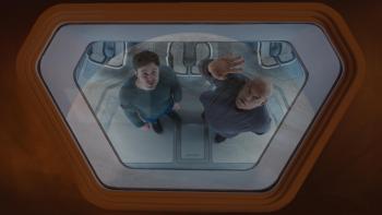 Slingshot Movie: Viewed from above, Captain Franks and John look out a porthole at something astonishing