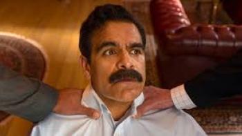 Son-in-Law Movie: Man with a mustache looking concerned, gripped by hands from both sides.