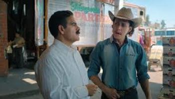Son-in-Law Movie: Two men talking outside, one in a cowboy hat, wearing casual and formal clothing.