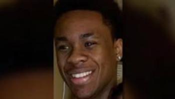 Still from Sound of the Police: Amir Locke, the African American man killed by police in Minnesota, looking to the left and smiling, wearing a hoop earring in his left ear