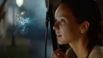 Starbright movie: Alexandra Dowling admires a glowing water-like fairy at night, looking amazed.