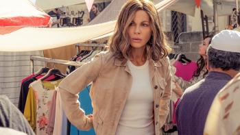 Stolen Girl movie: Kate Beckinsale stands, hands on hips, among racks of clothes