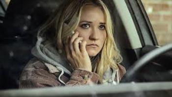 Stolen Baby: The Murder of Heidi Broussard: Emily Osment on a phone call in a car, looking concerned.