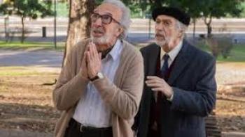Strangers in the Park Movie: Two older men in park, one making prayer gesture