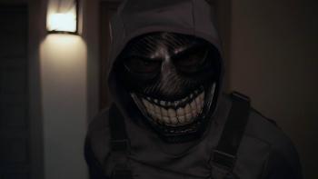 Stream Movie: A figure wearing a hood and a sinister, grinning mask leers menacingly