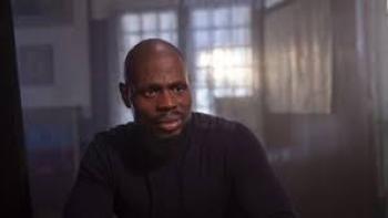 Street Flow Movie: Bald Black man sits by window