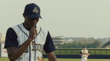 Sugar movie: Algenis Perez Soto holds his cross necklace in his hand as he walks onto the baseball field