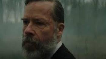 Sunrise: A close-up of a bearded Guy Pearce, with a misty woodland in the background.
