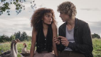 The Hunger Games: Sunrise on the Reaping movie: Joseph Zada and Whitney Peak sit together in a meadow