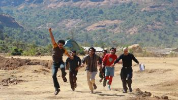 Superboys of Malegaon: A group of Indian men running and jumping