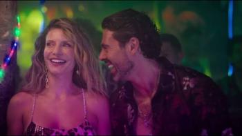 Susana and Elvira: No Plan B movie: Smiling couple in a vibrant, colorful club setting.