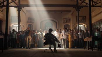 Sarkaru Vaari Paata: A silhouette of man holding some keys while sitting down with a crowd standing behind him