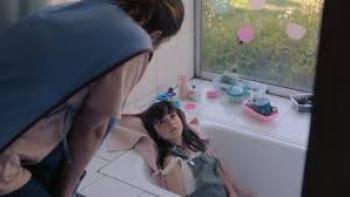 Swim to Me: Caretaker bathes little girl.