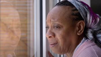 Hard Truths: A middle-aged Black woman looks mournfully out of the window