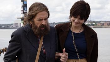 Bolan's Shoes: A bearded man is helped by a smiling woman