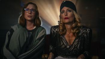 Teenage Sex and Death at Camp Miasma movie: Kris (Hannah Einbinder) and Billy Presley (Gillian Anderson) watch a movie, the projector behind them