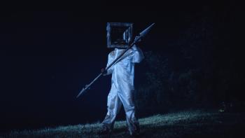 Teenage Sex and Death at Camp Miasma movie: Camp Miasma killer Little Death wears a vent mask and holds a spear on a lawn
